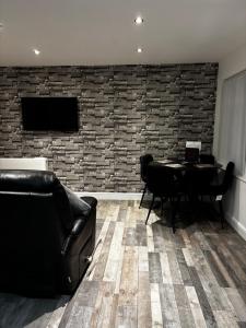 a living room with a couch and a table and a tv at Blackamores chalet in Mablethorpe
