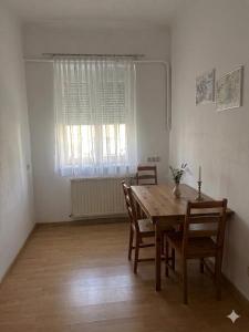 a dining room with a wooden table and chairs at Stratos Apartments in Laa an der Thaya