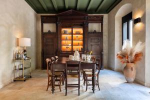 a dining room with a wooden table and chairs at Hotel Vella Nit in Canet de Mar