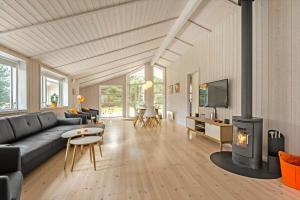 a living room with a couch and a fireplace at BV235-Oksbol-Kaervej-2 in Oksbøl