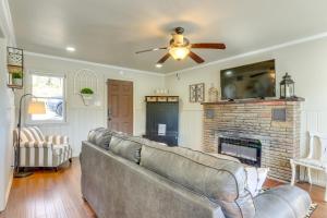 a living room with a couch and a fireplace at Lakefront Eucha Escape w/ Views & Boat Slip! in Eucha
