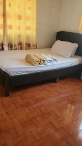 a bed in a room with towels on it at EASTDEE by Jaya in Lidlidda