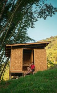 a woman sitting inside of a tiny house at Refugio Munay in Florián