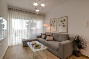 a living room with a couch and a glass table at Casa Angelica in Patitiri