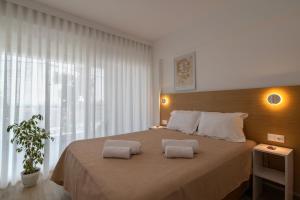 a bedroom with a large bed with two pillows on it at Casa Angelica in Patitiri