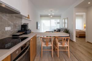 a kitchen and living room with a counter and chairs at Casa Angelica in Patitiri