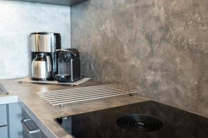 a kitchen with a coffee maker on a counter at Encore Seaside in Büsum