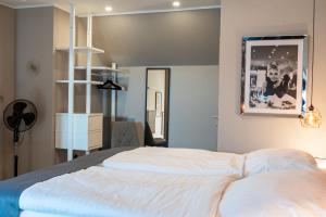 a bedroom with a large white bed in a room at Encore Seaside in Büsum