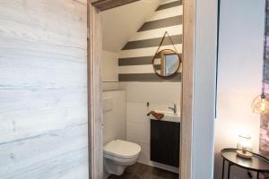 a bathroom with a toilet and a staircase at Encore Seaside in Büsum +17 photos