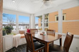 a dining room with a table and chairs and windows at Como Classic in Saint Paul