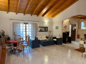 a living room with a couch and a table at Villa Erato Keratea in Keratea