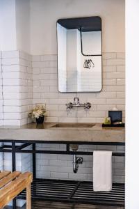 a bathroom with a sink and a mirror at Cardedeu Express Hotel in San Salvador
