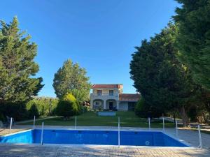 a house with a swimming pool in front of a house at Villa Erato Keratea in Keratea