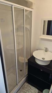 a bathroom with a glass shower and a sink at 16 farmfield in Skipsea