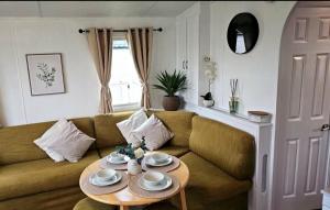 a living room with a couch and a table at 16 farmfield in Skipsea