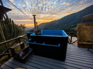 two trash cans sitting on a wooden deck with a sunset at Terraza Olmué Piscina y Tinaja Uso Exclusivo in Olmué