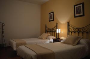 a hotel room with two beds and two lamps at CASA RURAL LA IBIENZA in Zarzuela del Pinar