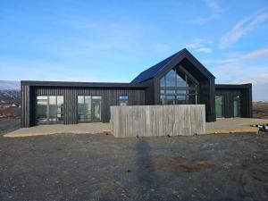 a house being constructed with a large building at Aurora luxury villa in Reykholt