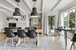 a kitchen and dining room with a table and chairs at BV374-Blavand-Krogsande-22 in Blåvand