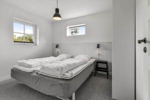 a bedroom with a bed in a room with a window at BV374-Blavand-Krogsande-22 in Blåvand