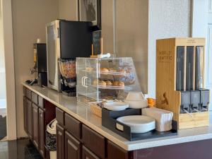 a counter top with a pile of plates and toilets at Whalers Inn and Suites in New Bedford