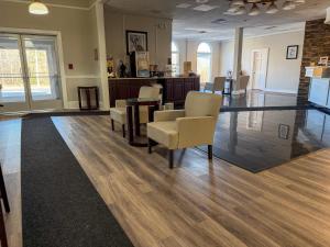 a waiting room with chairs and a table in a building at Whalers Inn and Suites in New Bedford +32 photos