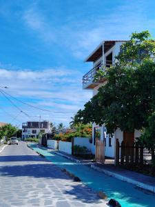 a street with a house and a blue road at Casa Almendro in Puerto Villamil