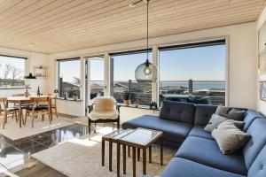 a living room with a blue couch and a table at BV138-Esbjerg-V-Sjelborgdalen-108 in Esbjerg