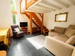 a living room with a couch and chairs and a table at Rural Studio with Shared Pool, Large Gardens & Tennis, Dog Friendly! Chichester Holiday Properties in Chichester