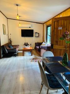 a living room with a couch and a table at Cabañas Los Glaciares in Coñaripe