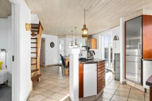 a kitchen and dining room with a table at BV277-Blavand-Klitvej-4 in Blåvand