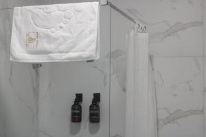 a white bag and two bottles in a closet at Square Garden apartment in Novi Sad +25 photos