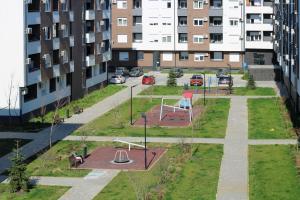 a park with a playground in the middle of a city at Square Garden apartment in Novi Sad