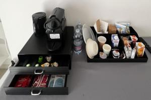 two black boxes filled with food and drinks on a counter at R&B Emilia in Cadeo