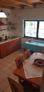 a kitchen with a table and a table and chairs at LeśnyZakątekNysa in Skorochow