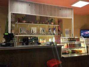 a counter in a restaurant with a shelf of wine glasses at Ahmad sweet home in Vardø