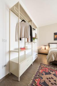 a white closet with white shelves and a bed at Casa Pulverun in Domodossola