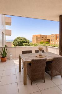 a dining room with a wooden table and chairs at Mindelo apart in front of the best beach of North Portugal in Mindelo