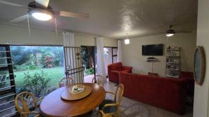 a living room with a table and a couch at Beach Bliss Retreat in Margate