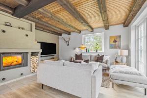 a living room with a couch and a fireplace at BV264-Blavand-Solhaven-47 in Blåvand