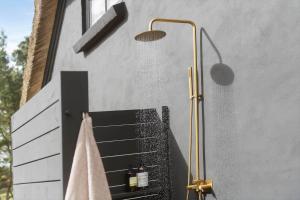a bathroom with a shower and a towel at BV264-Blavand-Solhaven-47 in Blåvand +45 photos