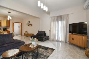 a living room with a couch and a table at Kostaras Comfort Stay in Dispilio