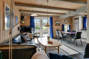 a living room with a couch and a table at BV348-Blavand-Fyrgarden-19 in Blåvand