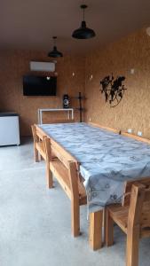 a large wooden table in a room with two benches at La Su in Duggan