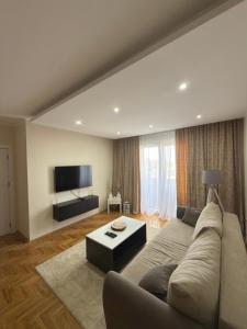 a living room with a couch and a tv at Grand Line in Sombor
