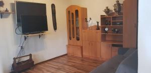 a living room with a flat screen tv on a wall at LeśnyZakątekNysa in Skorochow