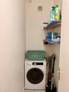 a washing machine with a green basket on top of it at Villa Eli -6pers- piscine in Petit-Bourg