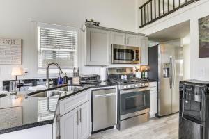 a kitchen with stainless steel appliances and white cabinets at Great Outdoor Space! Serene Getaway in Oakland in Oakland +20 photos