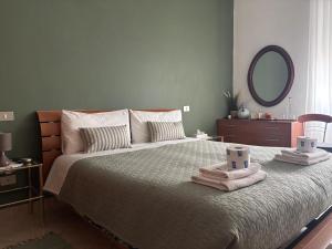 a bedroom with a large bed with two towels on it at B&B Altea in Pescara