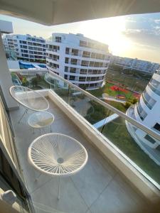 a balcony with two tables and chairs on a building at Golden Breeze in Cartagena de Indias